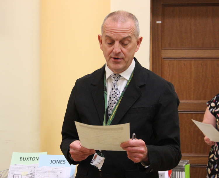 Election officer Brian declares the results.