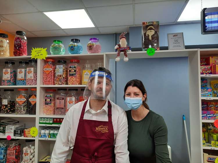 The owners of Warner's Traditional Sweet shop smiling in between customers