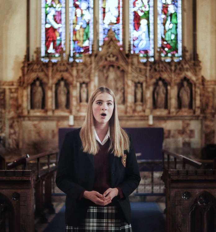 Oakham School pupil singing at previous church event