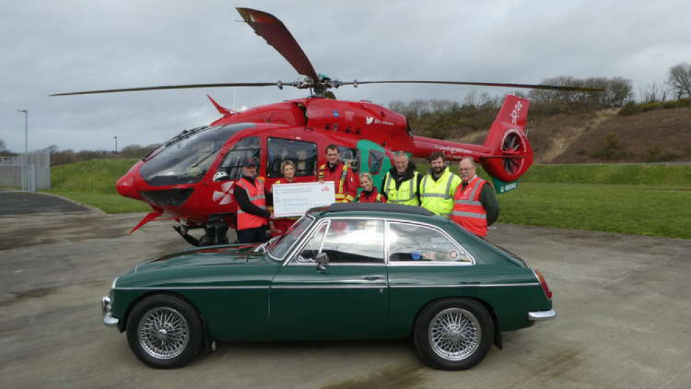 Bridgend MG Owners Club President, Paul Bullock and Ed Griffith during the cheque presentation with Wales Air Ambulance medics. (Image credit: Wales Air Ambulance)