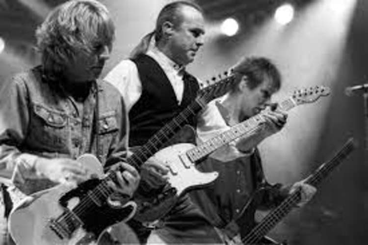John performing with Status Quo. Pictured: Francis Rossi and Rick Parfitt, who died aged 68 in 2016