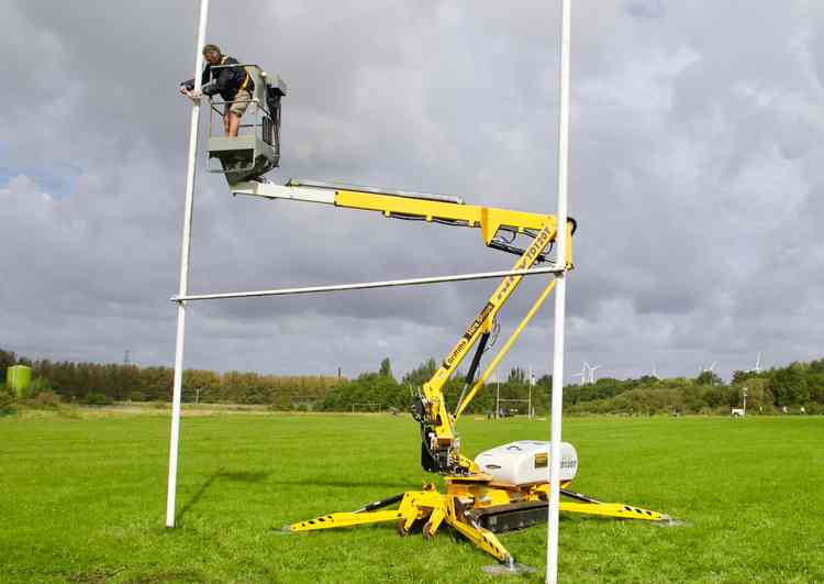 Volunteers help to maintain Helsby RUFC's goalposts