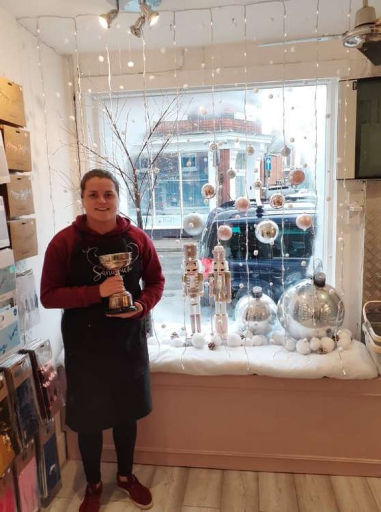 Judy with the trophy in front of the window