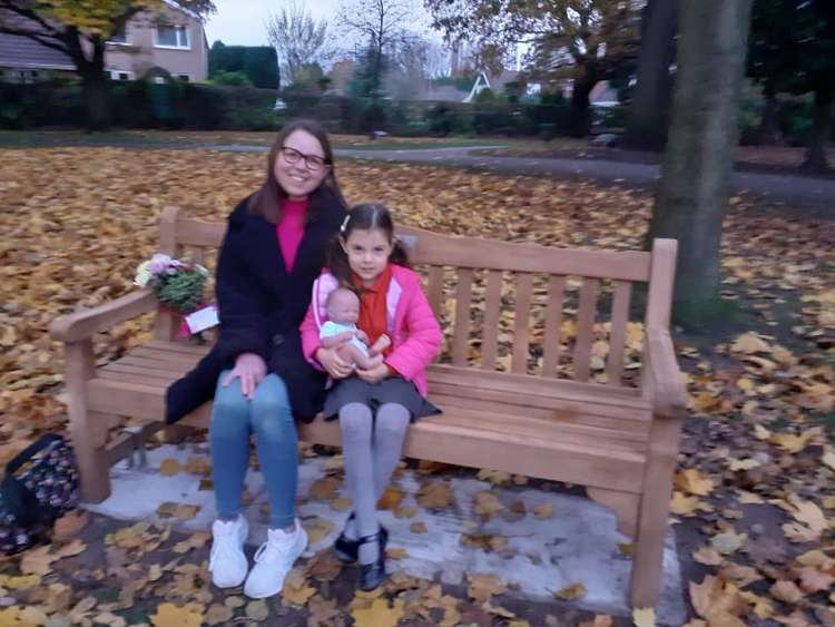 Louise Powney sitting on the bench with daughter Franki