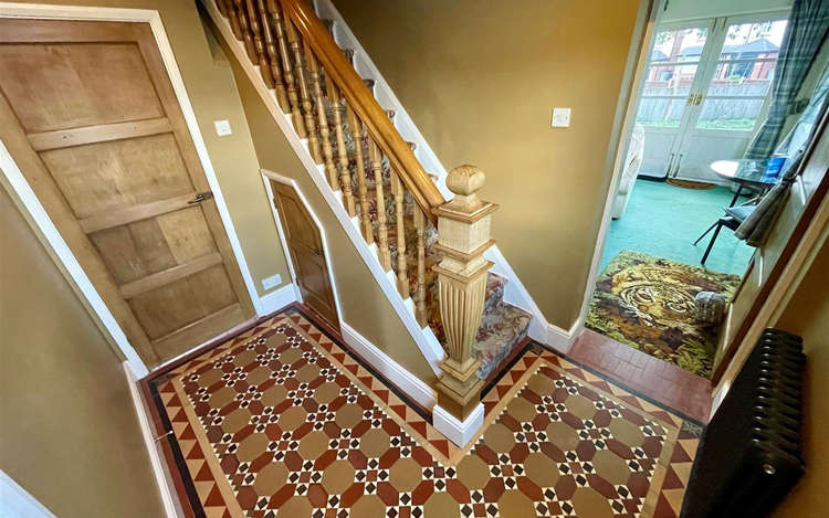 Reclaimed Minton mosaic tiled flooring in the hallway.