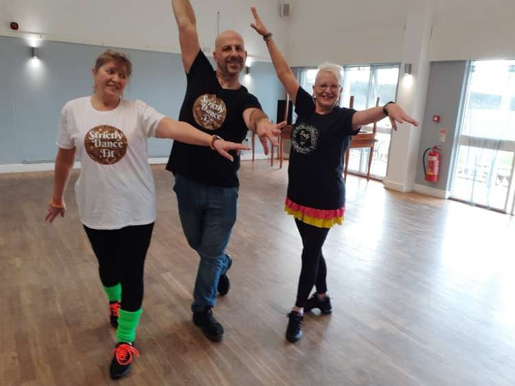 Students Anne Bridgett (left) and Glynis Roberts model the T-shirts with Mark after a Sandbach class