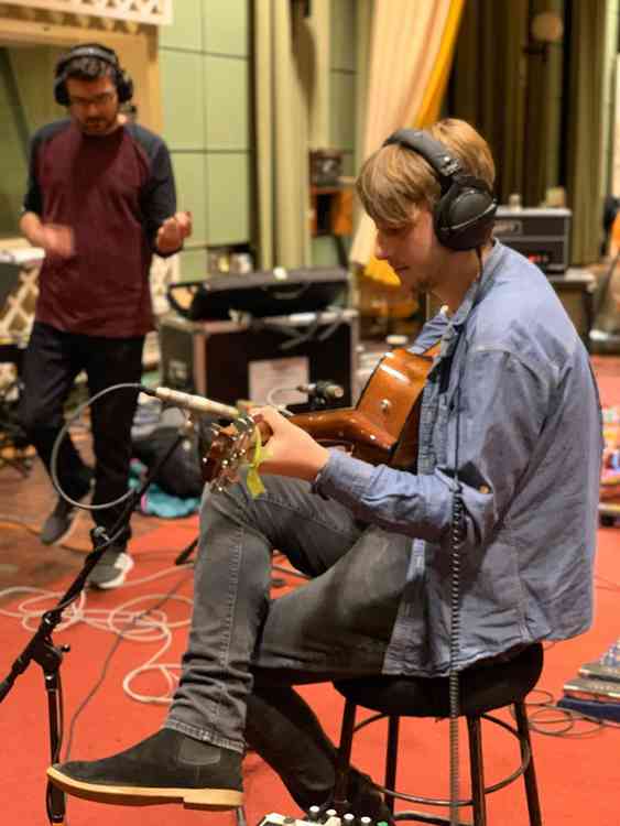 Harrison performing acoustic guitar on some of the tracks recorded