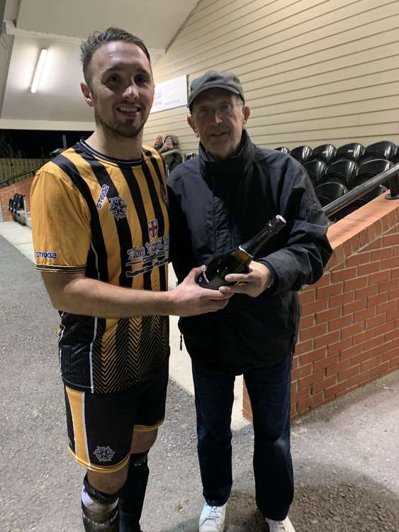 Axminster News sports editor Philip Evans presents Jamie Price with the man-of-the-match award after Axminster Town's 1-0 win over Hinton Town
