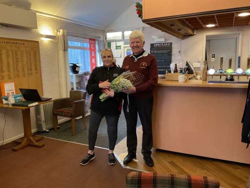 Axe Cliff catering manager Clare receiving a bouquet fro Seniors' captain John Hanna