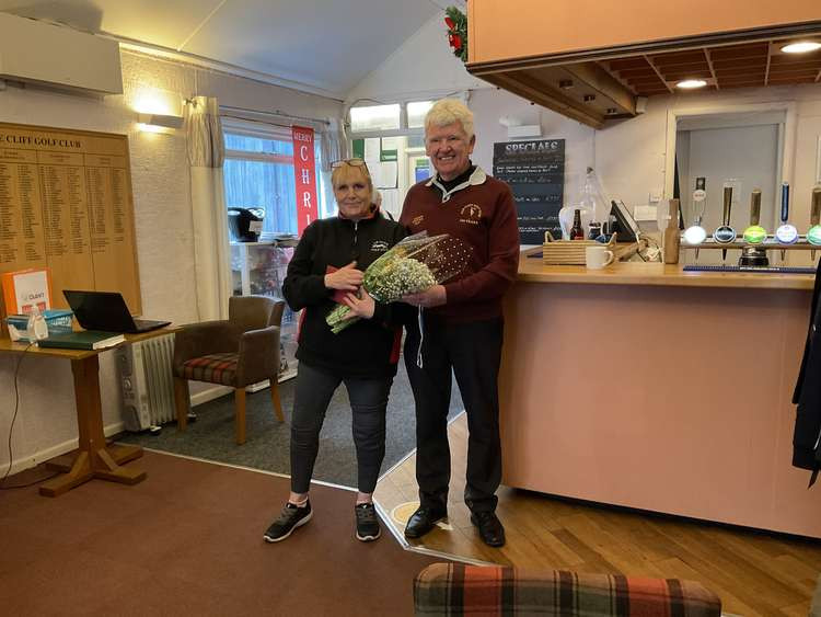 Axe Cliff catering manager Clare receiving a bouquet fro Seniors' captain John Hanna