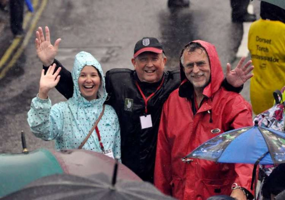 Soaked to the bone while out covering the Olympic Torch Relay in 2012 – myself, Dad and Geoff Baker, taken by Geoff's partner Jill Newton who was poised with camera in the window above Quality Corner