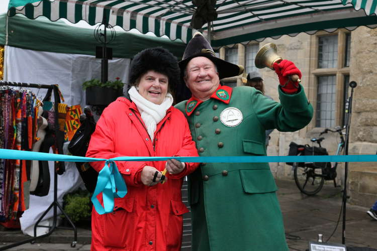 Cllr Ros Wyke, Leader of Mendip District Council and Len Sweales, Wells Town Crier declaring 'Christmas in Wells' open at the ribbon cutting ceremony.