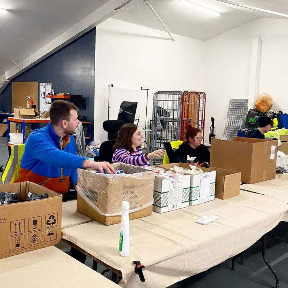 Packing up first aid kits on table lent by Gilcombe Farm