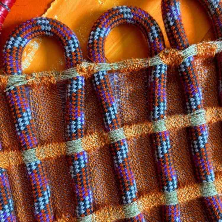 Climbing ropes incorporated into a weaving, using colours based on the houses in Burano, Italy and patterns inspired by azulejo tiles.