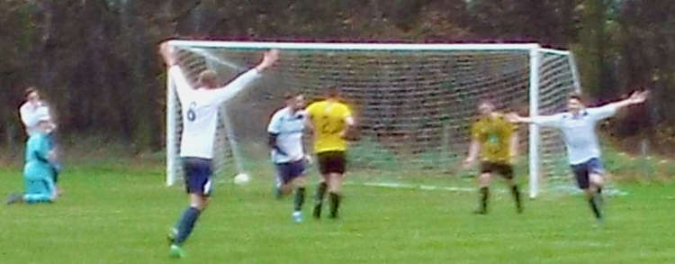 Woolverstone celebrate Hayden Catchpole's second goal which has kept them top of the division