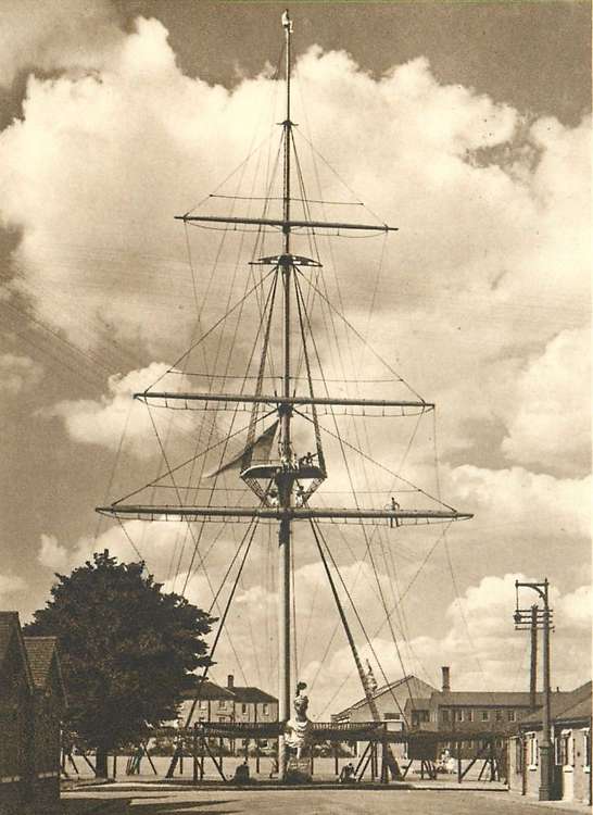 Boy sitting on the button of HMS Ganges mast