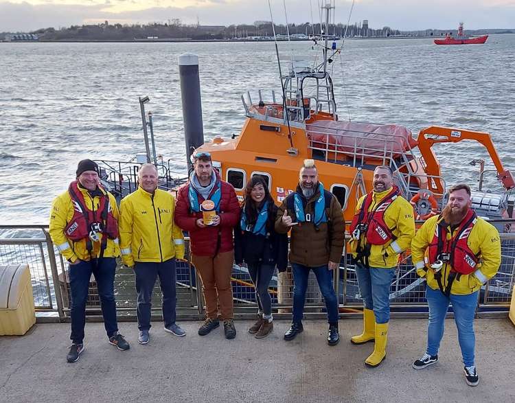 Antony Charles with RNLI Harwich crew and paddleboard supporters