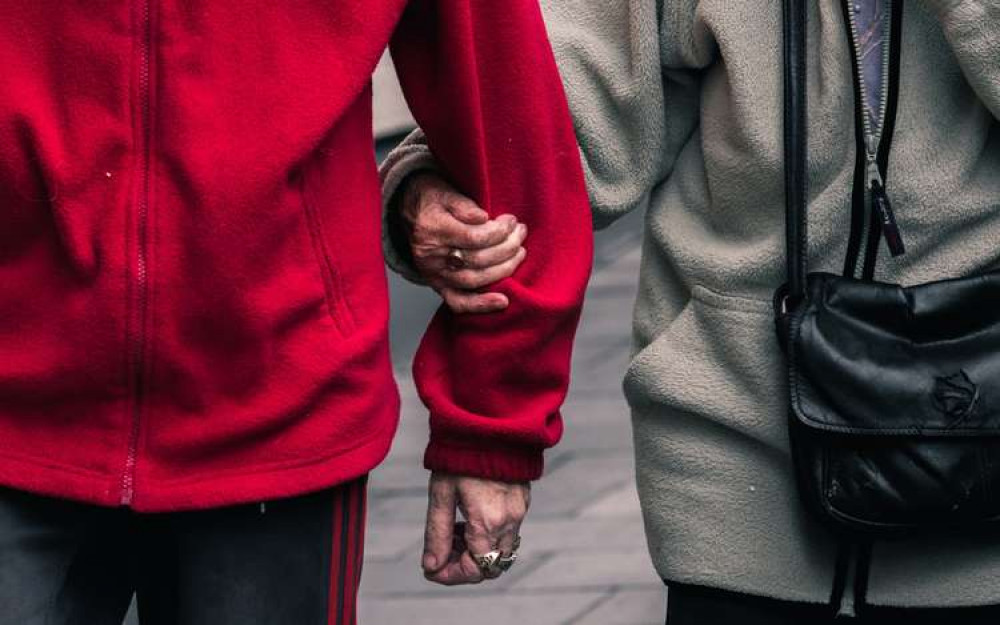 Two people holding arms (Image: Jack Finnigan/Unsplash)