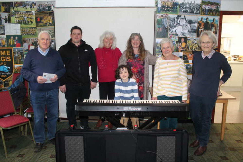 Pacey Shephard pictured at the recital he gave to The Welcome Club in Lyme Regis. Pacey's dad Ben is pictured second from the left.