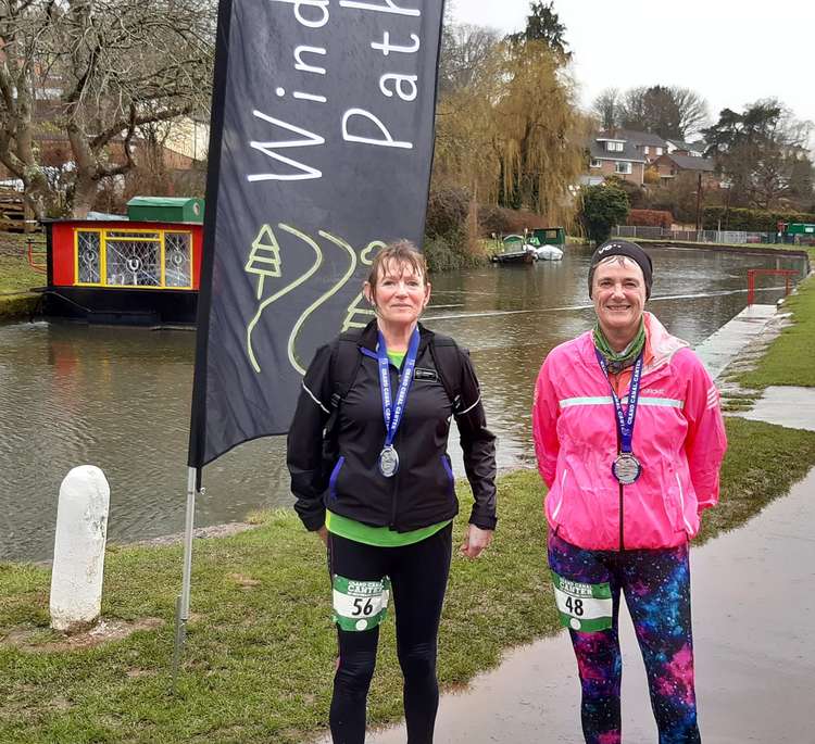 Smiling despite being wet through, Jo Earlam and Jane Hemsworth with their medals