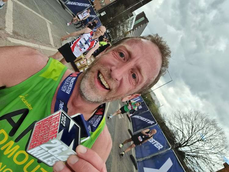 Antony Hall with his impressive Manchester Marathon medal