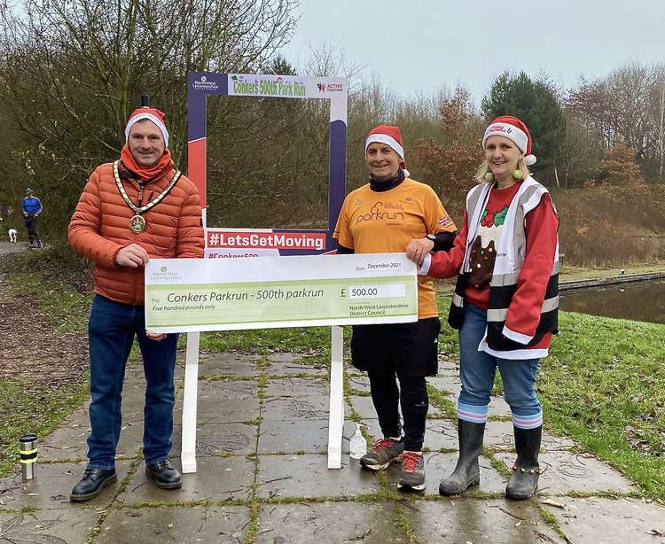 L-R - Cllr Russell Boam, Deputy Chairman of North West Leicestershire District Council with Conkers parkrun volunteers Roger Cobb and Nicola Briggs