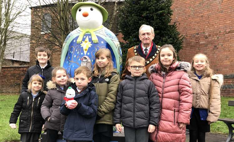 The winners of Belmont Primary School's The Snowman and The Snowdog Sculpture Design Challenge with their designs. They were presented with their prizes by Chairman of South Derbyshire District Council, Cllr Malcolm Gee.