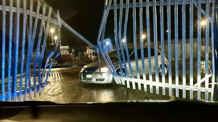 The aftermath of the crash shows the car and the smashed fencing. Photo: Swadlincote SNT