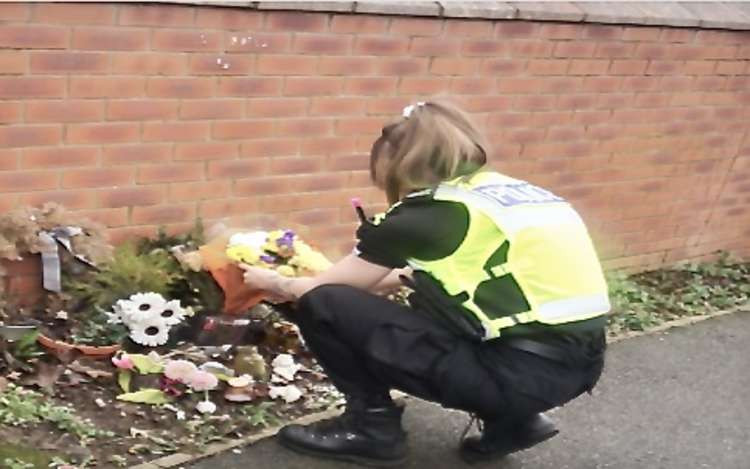 PC Jo Saddington has laid flowers in memory of Benj on behalf of Swadlincote Police. Photo: Swadlincote SNT