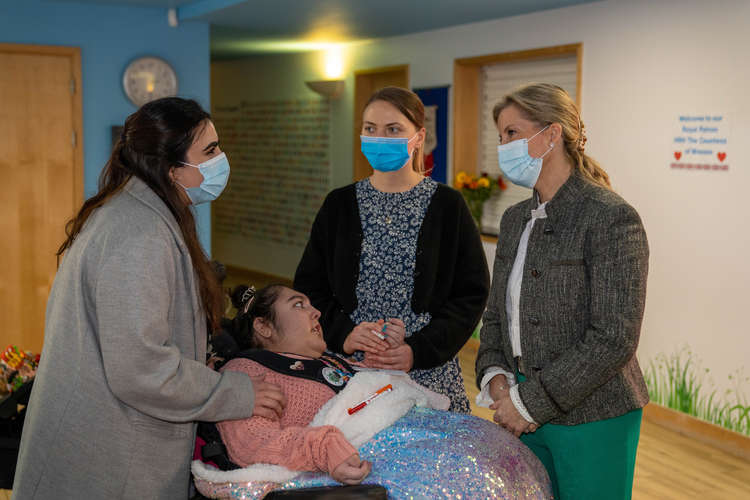 Supported young adult, Humairaa, affectionately known as Spud, with sister Tamanna (left) and carer Ashley meet HRH the Countess of Wessex at Shooting Star Hospice in Hampton (Image: Shooting Star Children's Hospices)