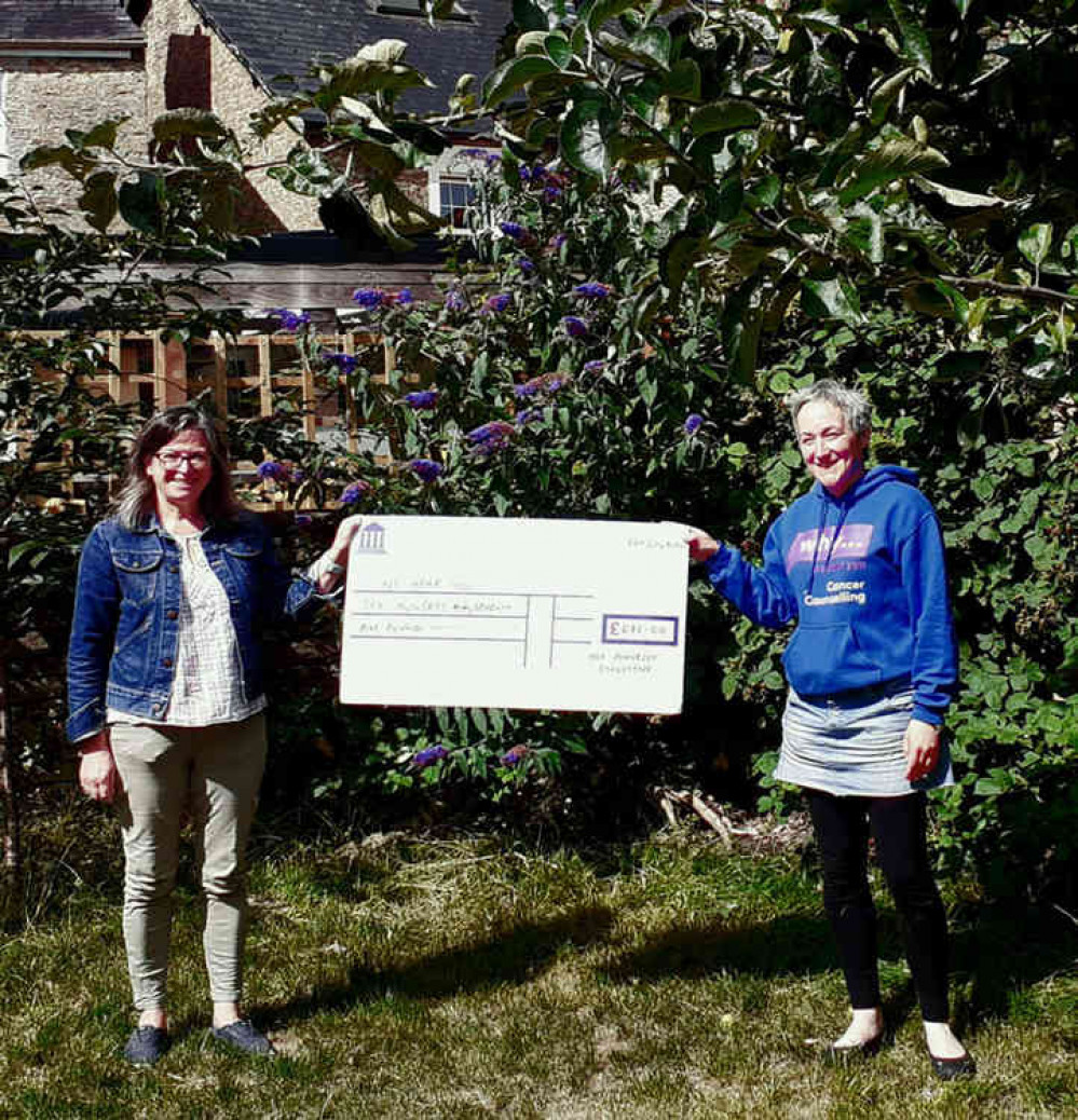 Jess Hyde of The Somerset Collective presents Lucy McMahon from WHY with the cheque