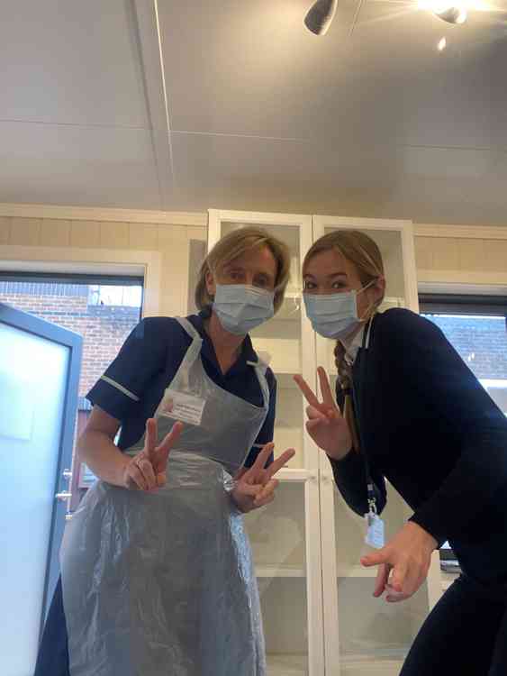 Millfield student Millie helping her mum at the Royal Surrey Hospital in Guildford