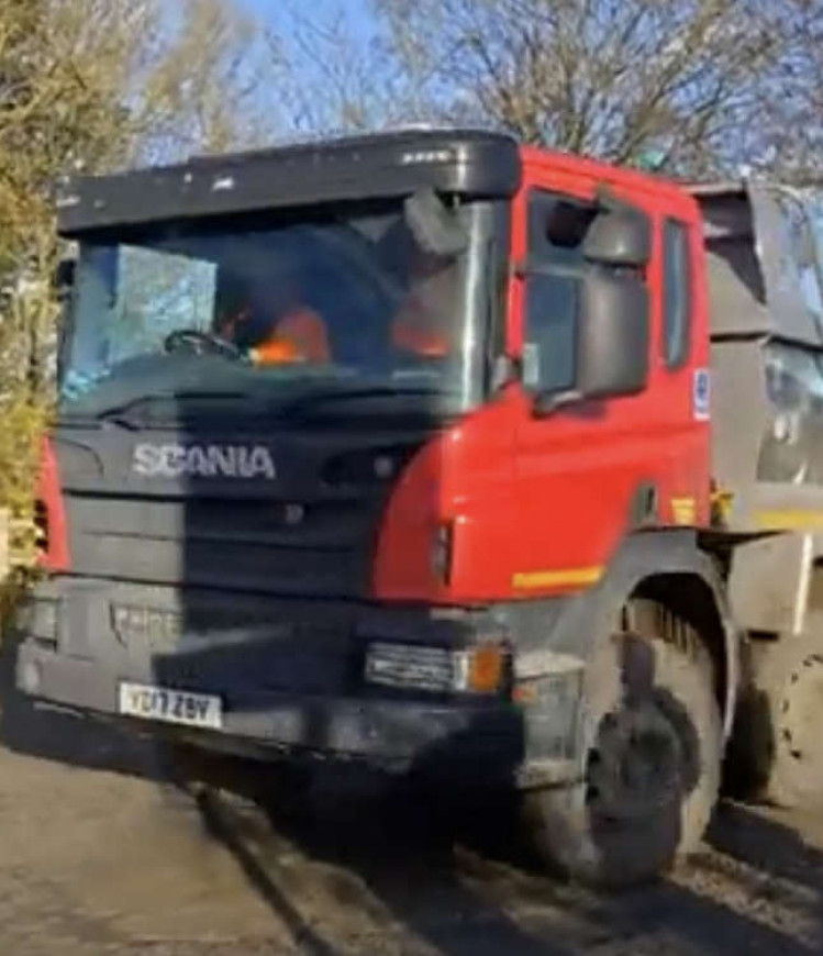 The last truck leaves Walsh's site.