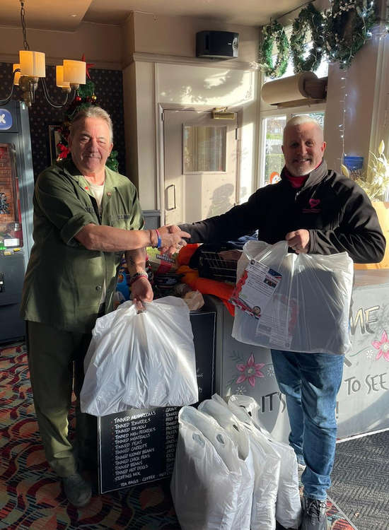 Marc Chattaway hands over the collected items to Steve Stuart.