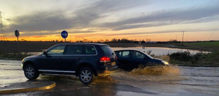 Most cars were able to negotiate the flood safely, but at least one was damaged as water covered a kerb.