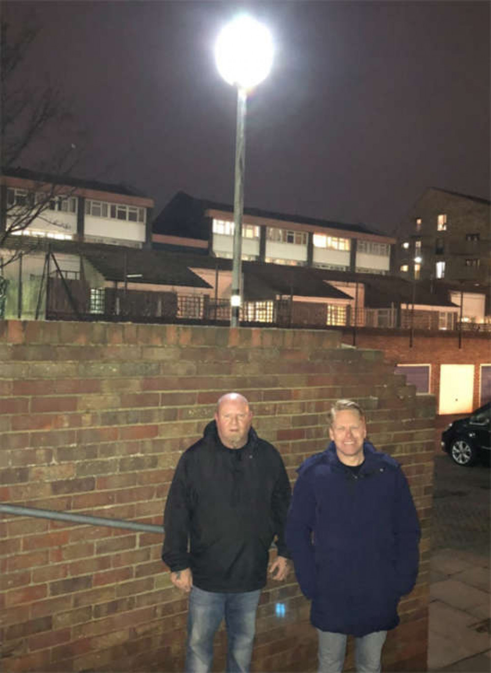 Residents Ian Zanders (left) and Cllr Martin Kerin under one of the repaired lights.