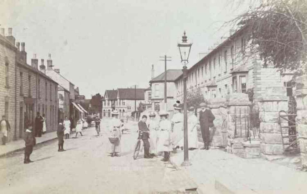 A postcard showing part of Street High Street in the early 1900s