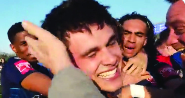 Jon Benton celebrates his match-winning goal with teammates and the crowd