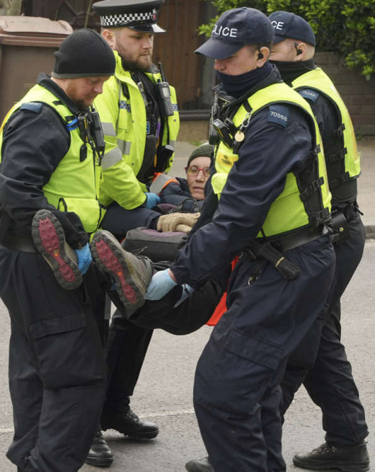 Officers carry away a protester yesterday (8 April). Picture by Stephen Huntley.