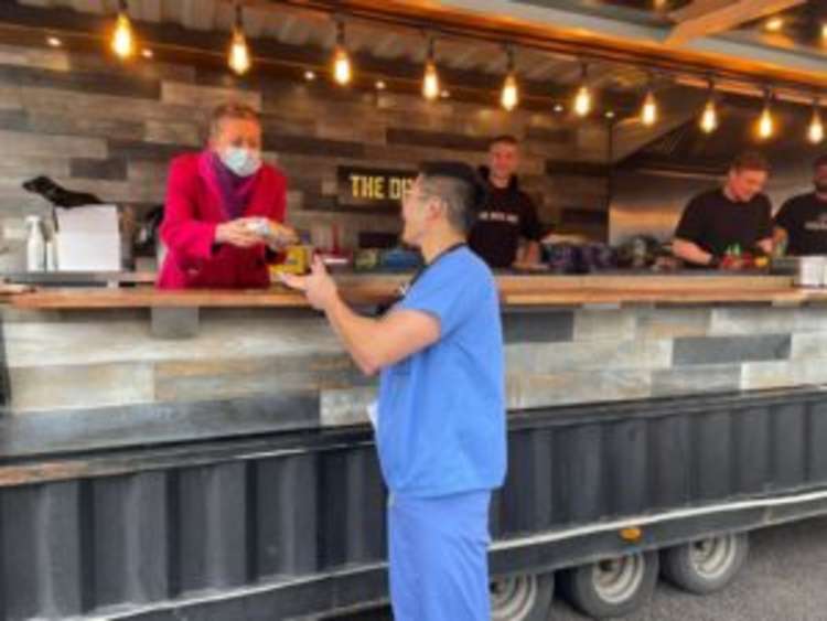 Jacqueline Totterdell serving Dr Daniel Yiu at the food festival (Image: St George's Hosptial)