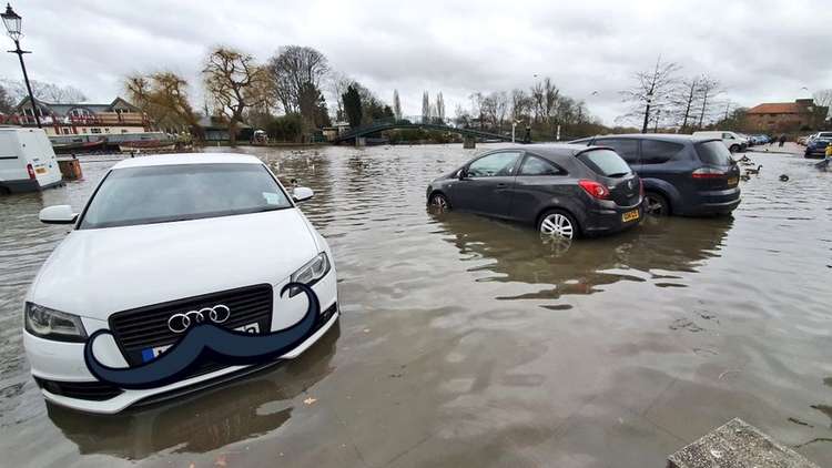 Cars left unattended partially submerged in the water. Credit: Captain Quack.