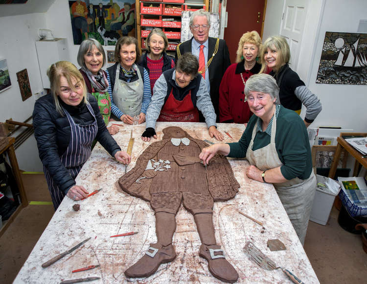 The artist Philippa Threlfall, centre, working on the clay template for the Bishop of Bath and Wells with the Mayor, Mayoress and some of her helpers