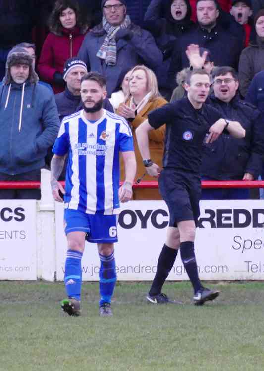 The long walk: Kurton Mewies sees the red mist and an approriately-coloured card for a scissor kick right in front of the Adders dugout