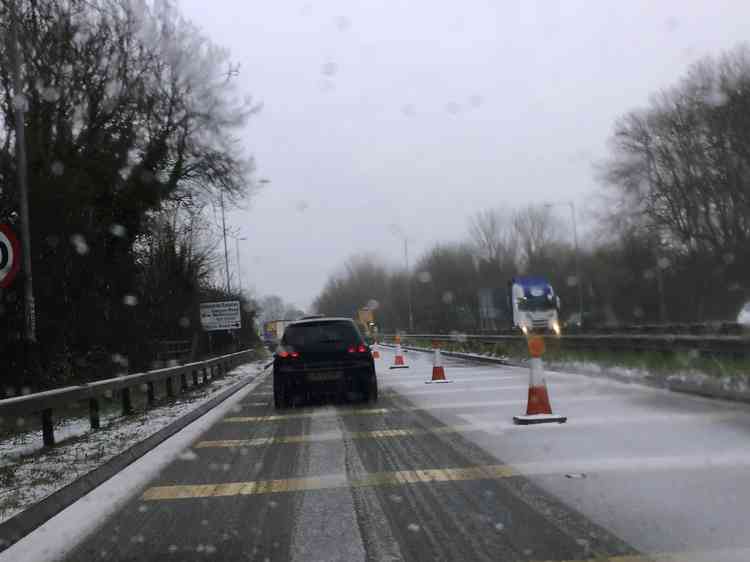 Tricky surface: The Mancetter island roadworks caught the brunt of the brief blizzard