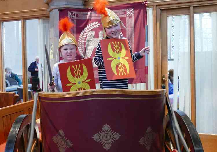 Ready to do battle: Two youngsters enjoy a ride in a Roman chariot