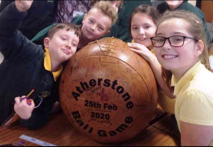 Signing up: Schoolchildren add their names to the 2020 ball