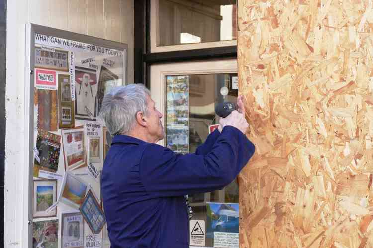 Last minute adjustment: There's an art to this boarding up, at Atherstone Gallery