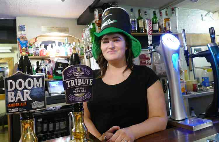 Doom Bar: The sign says it all as Robyn Northall tries to remain cheerful at the Black Horse in Long Street