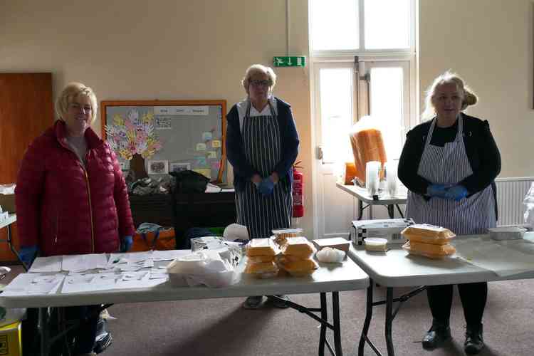 Table laid: Volunteers, from left, Lisa Hathaway, Stephen Reay and Angie Spencer