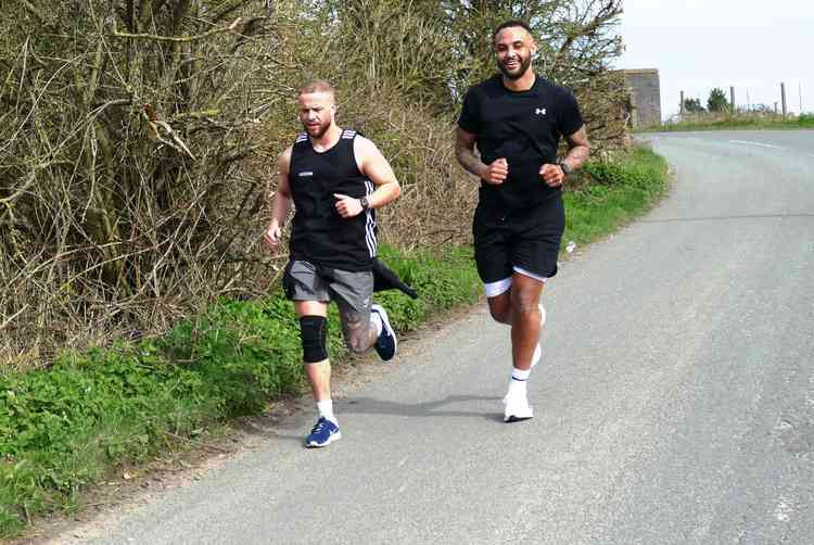 Keeping on running: Joe Obi, right, out in Mancetter with team manager Adam Davies